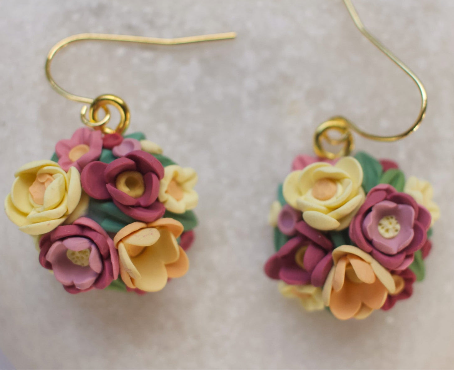 Floral earrings on a heart-shaped stone background