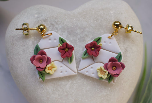 Pair of envelope shaped earrings with floral designs on a heart-shaped stone