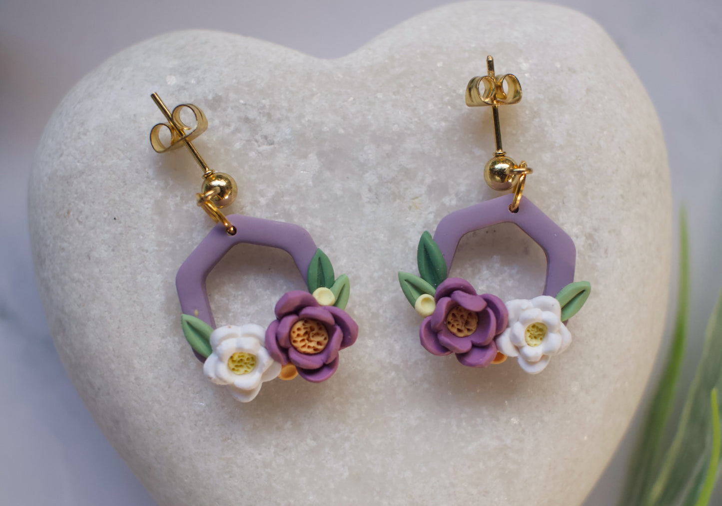 Purple hexagon floral earrings on a heart-shaped stone