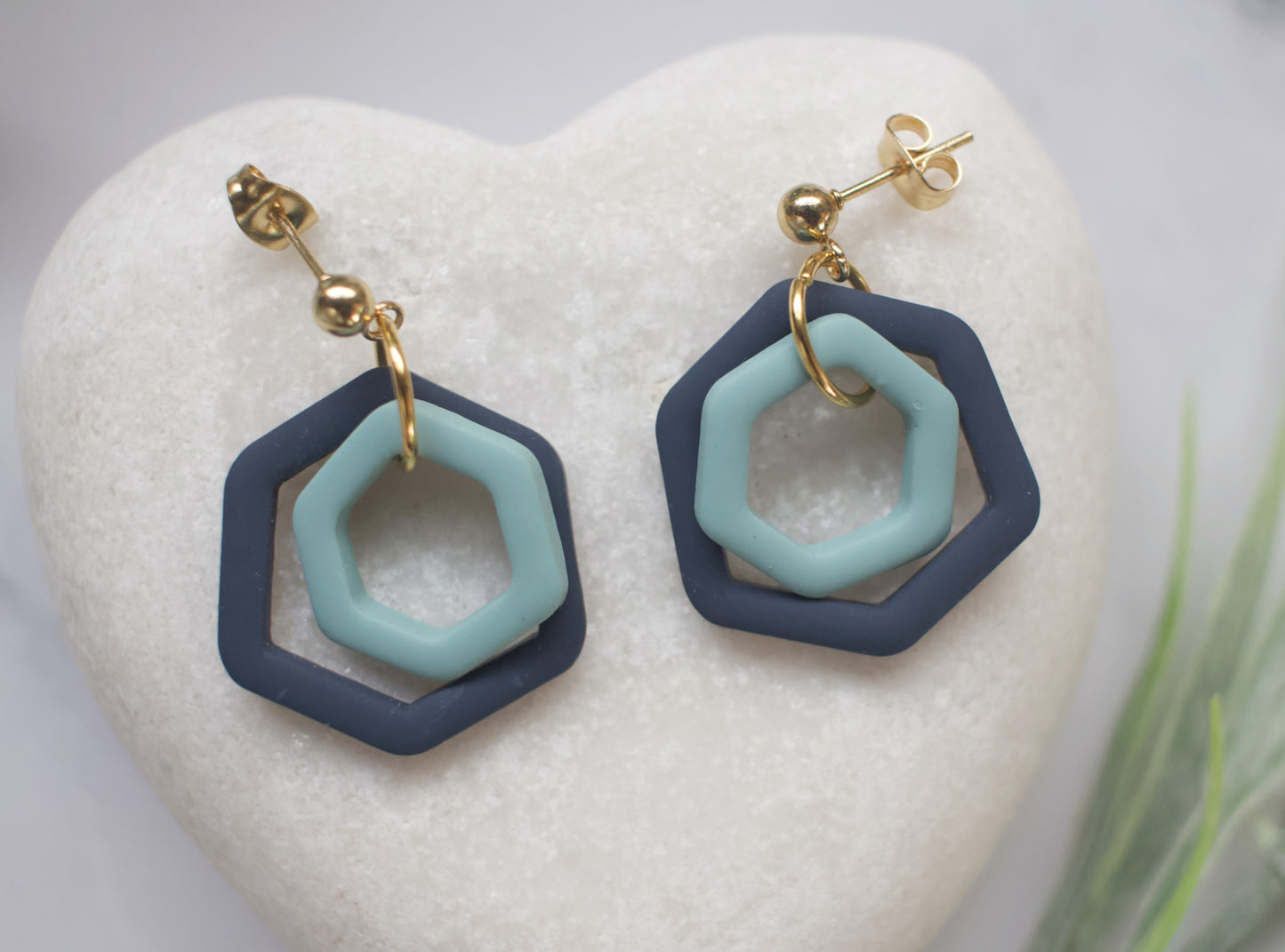 Hexagonal earrings with blue and navy design on a white heart-shaped stone