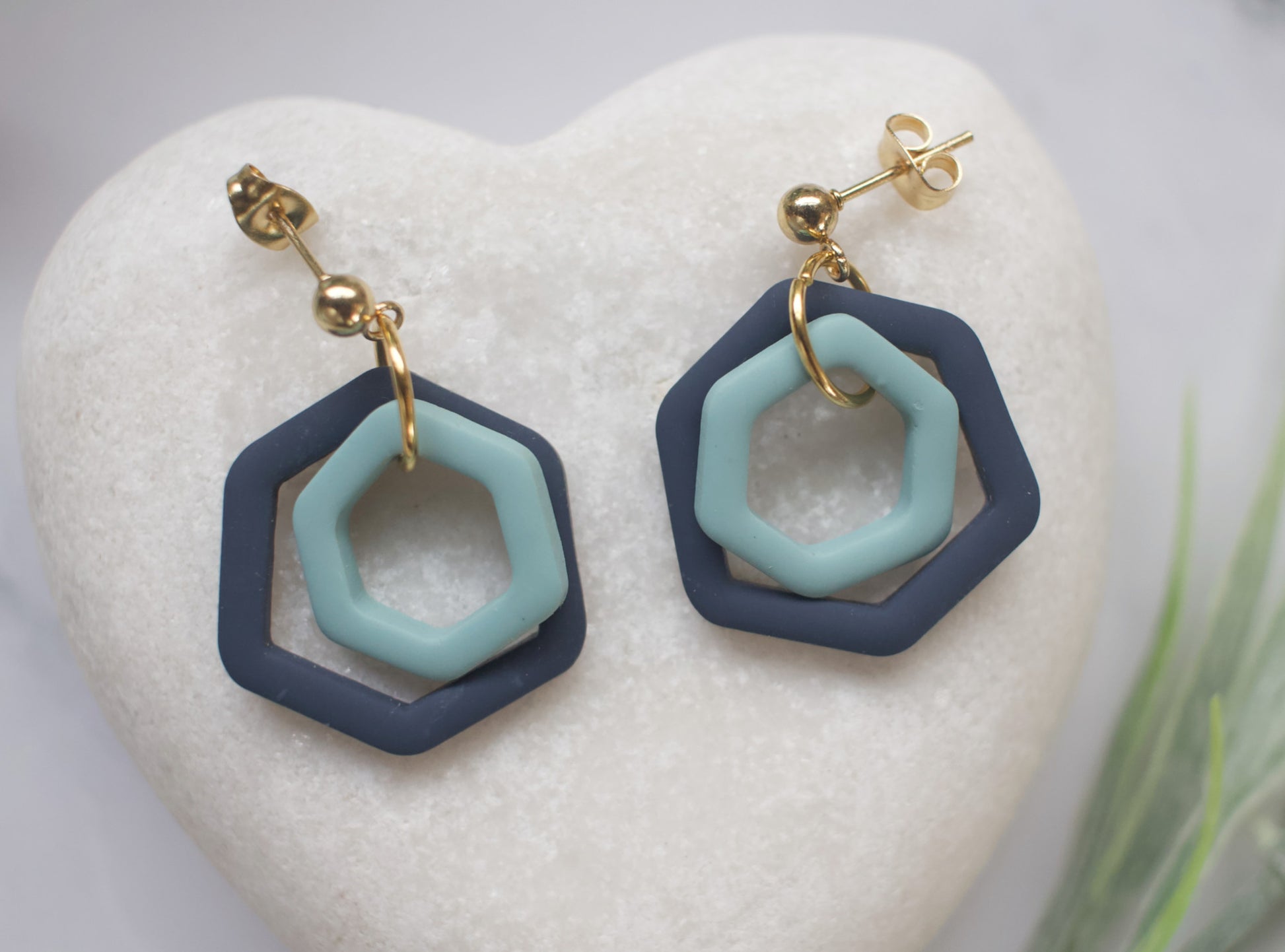 Hexagonal earrings with blue and navy design on a white heart-shaped stone
