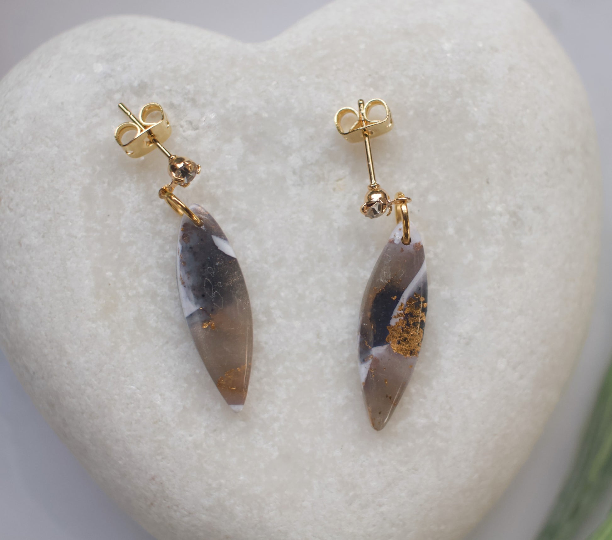 Pair of earrings with gold accents on a heart-shaped stone