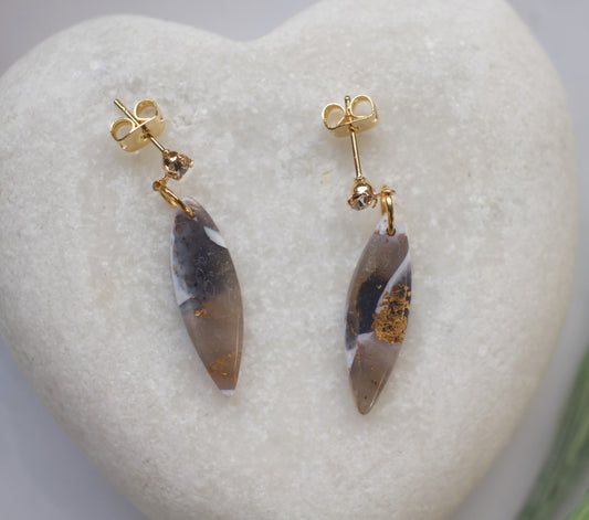 Pair of earrings with gold accents on a heart-shaped stone