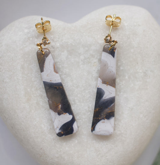 Marbled patterned earrings with gold posts on a heart-shaped stone