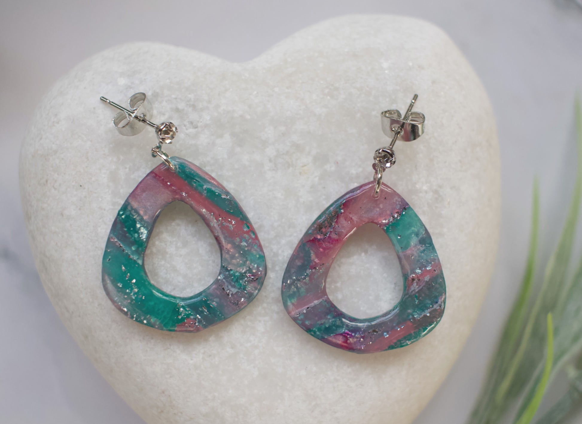 Multicolored teardrop earrings on a white heart-shaped stone